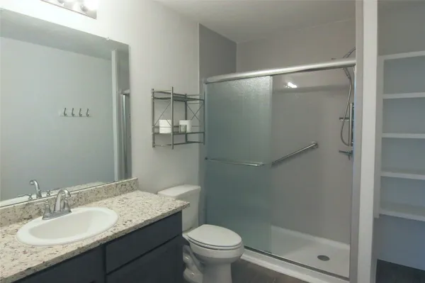 an empty room with wooden floor and entrance