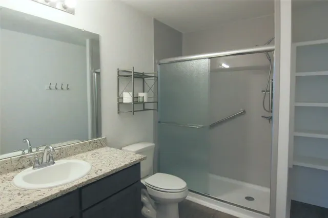 an empty room with wooden floor and entrance