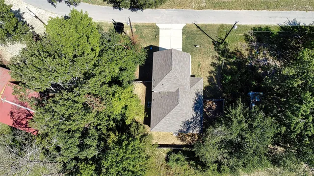 an aerial view of city and lake with boats