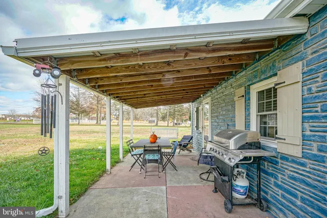 a patio with yard table and chairs