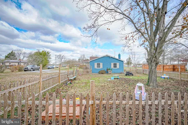 a front view of a house with a yard covered in snow