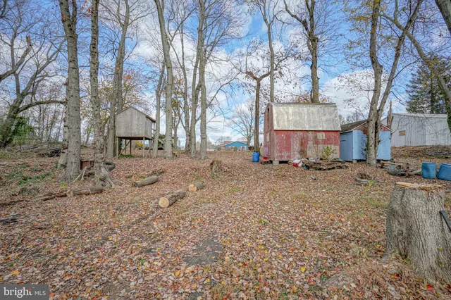 a view of a house with a yard covered in snow
