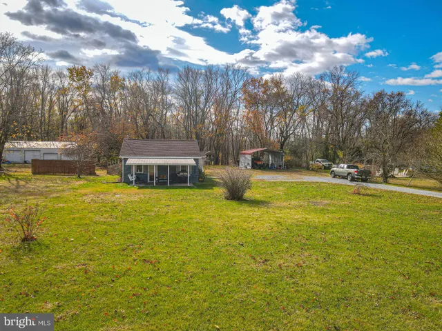 a view of a swimming pool with an outdoor seating and a yard