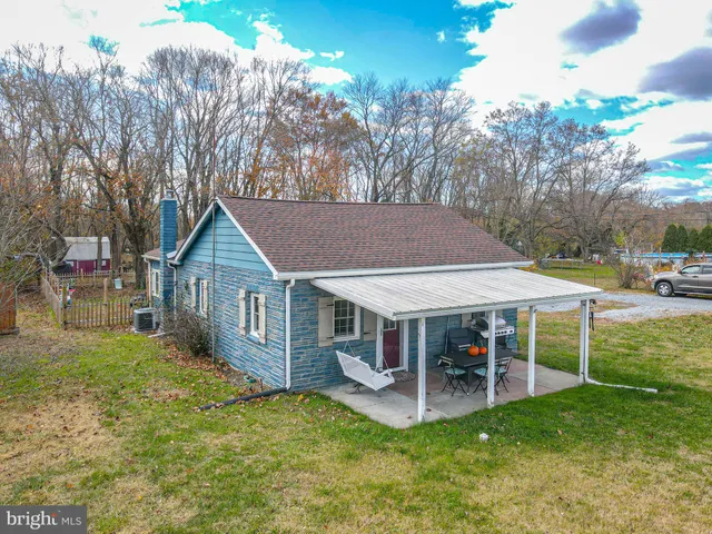 a view of a house with a yard porch and sitting area