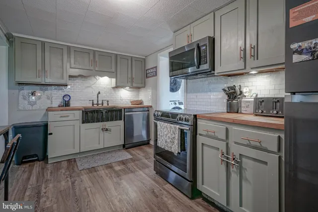 a kitchen with a sink a stove and cabinets