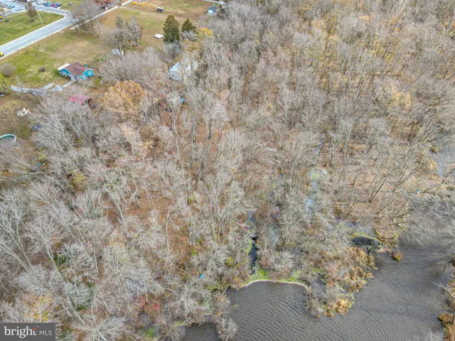 a view of water heater room with wooden floor