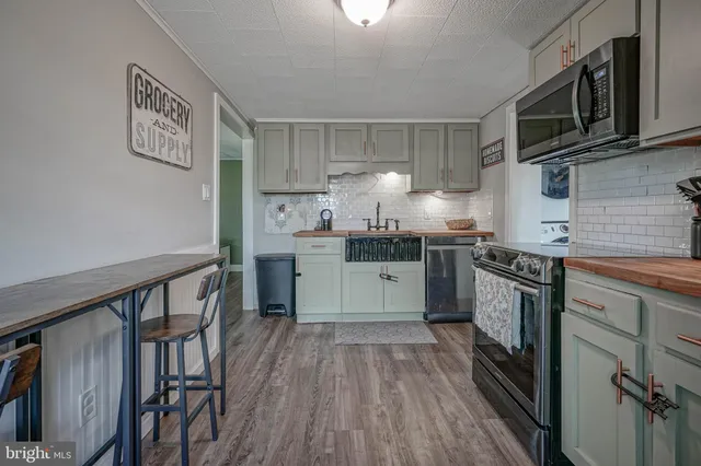 a kitchen with a stove top oven sink and cabinets