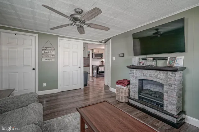 a living room with furniture a flat screen tv and a fireplace