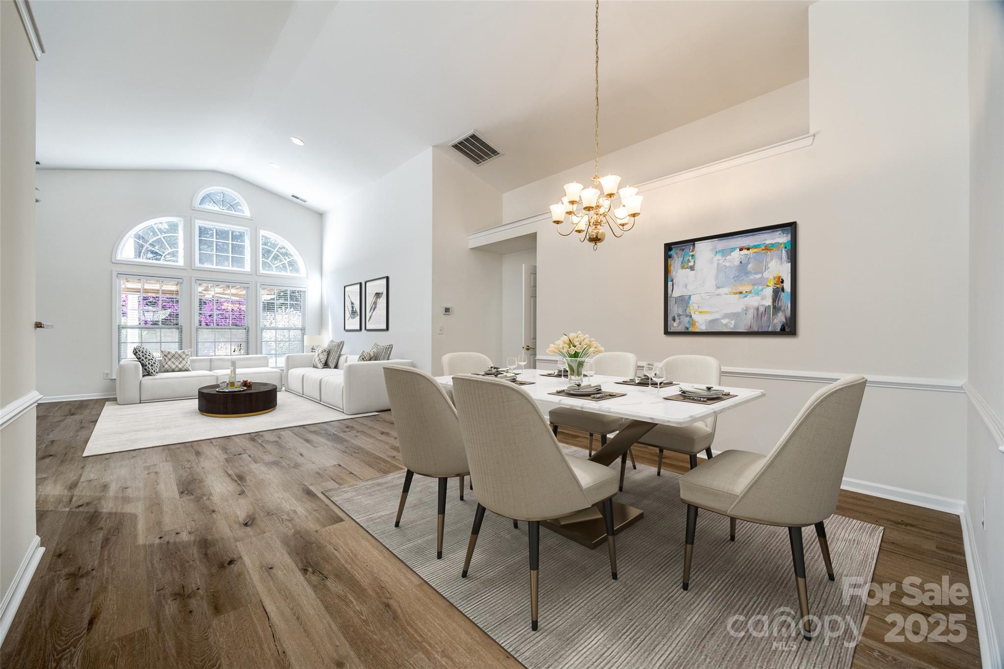 a view of a dining room with furniture and chandelier