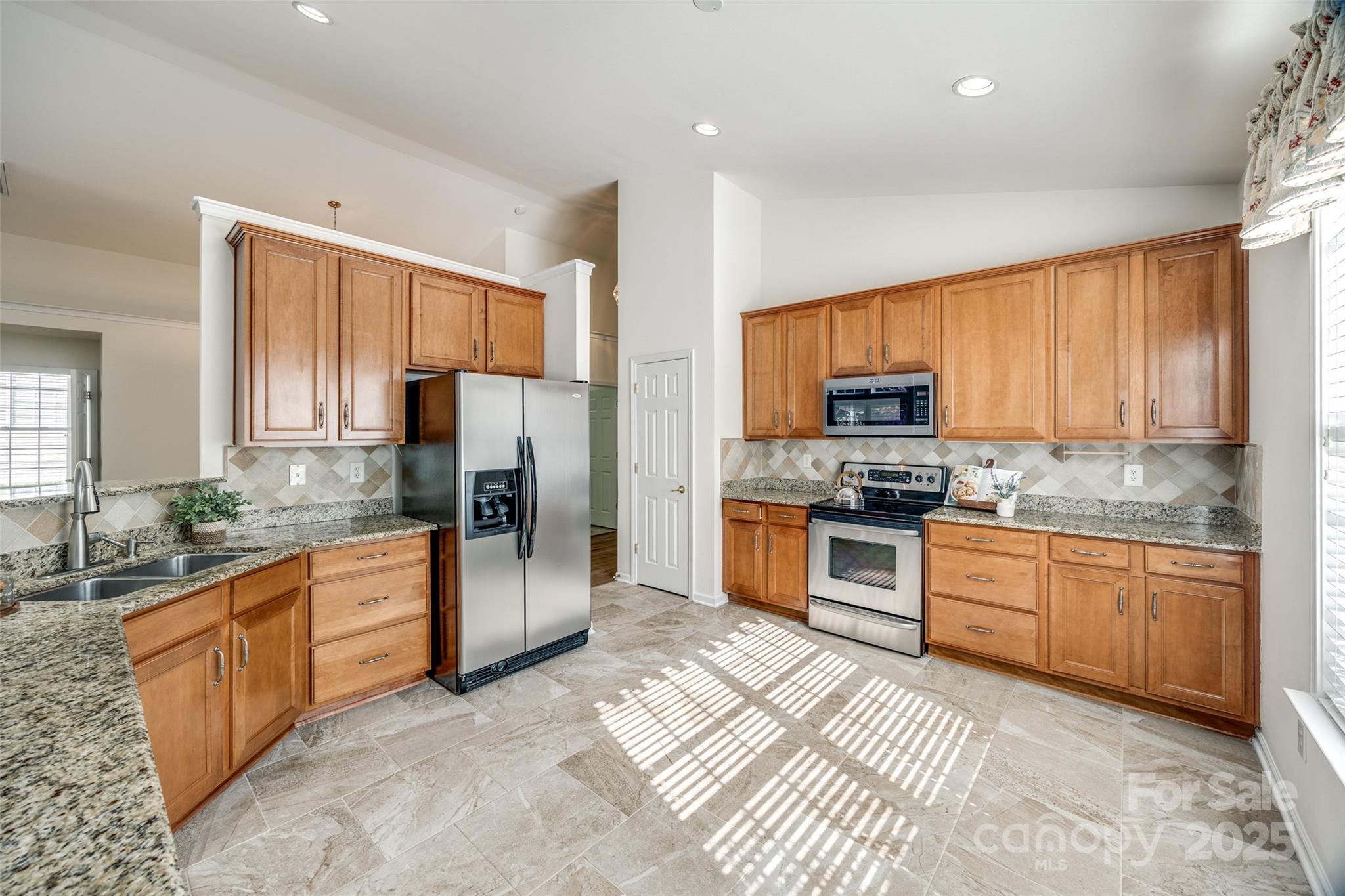 974 Platinum Drive Fort Mill, SC 29708 - Photo 17 of 48 a kitchen with granite countertop stainless steel appliances and cabinets
