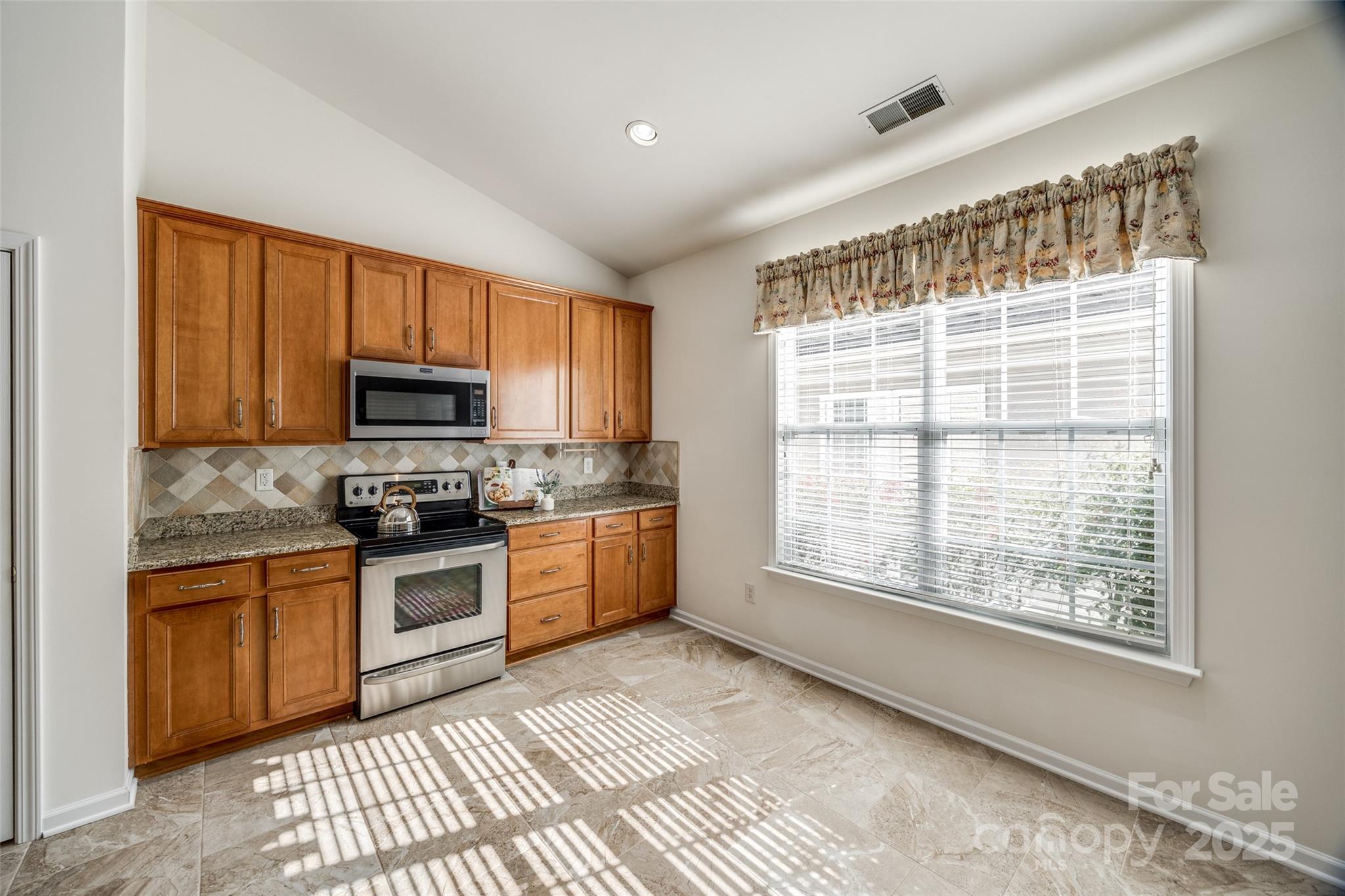 974 Platinum Drive Fort Mill, SC 29708 - Photo 18 of 48 a kitchen with stainless steel appliances granite countertop a stove sink and microwave