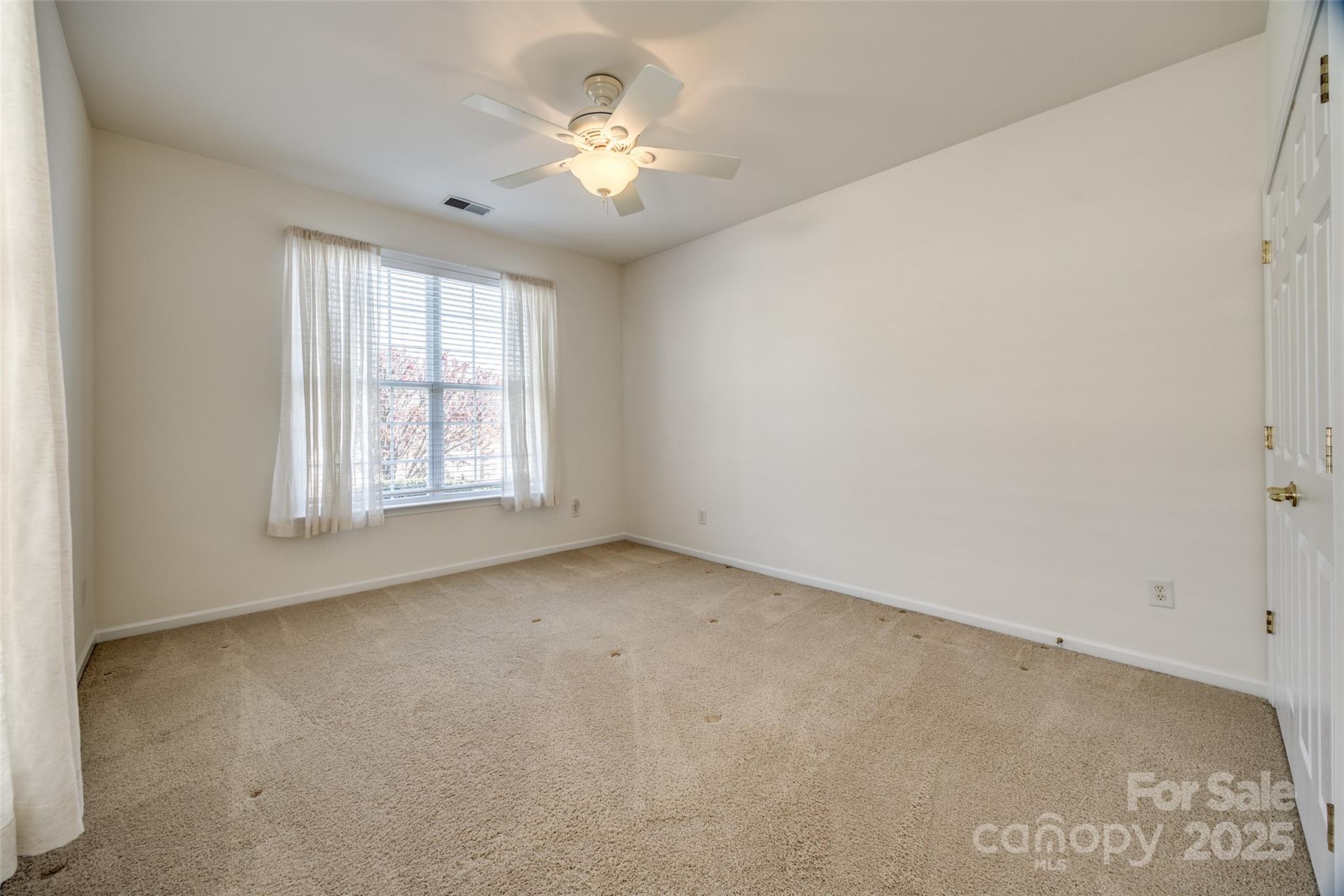 974 Platinum Drive Fort Mill, SC 29708 - Photo 28 of 48 an empty room with a chandelier fan and windows