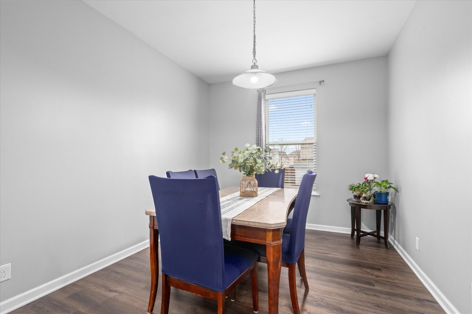 278 Windett Ridge Road Yorkville, IL 60560 - Photo 6 of 31 a dining room with furniture potted plants and wooden floor