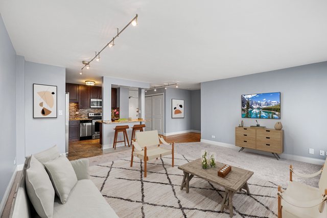5455 North Sheridan Road, Unit 711 Chicago, IL 60640 - Photo 4 of 25 a living room with furniture and wooden floor