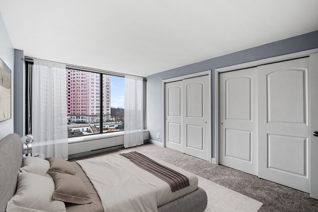 5455 North Sheridan Road, Unit 711 Chicago, IL 60640 - Photo 9 of 25 a spacious bedroom with a bed and a large window