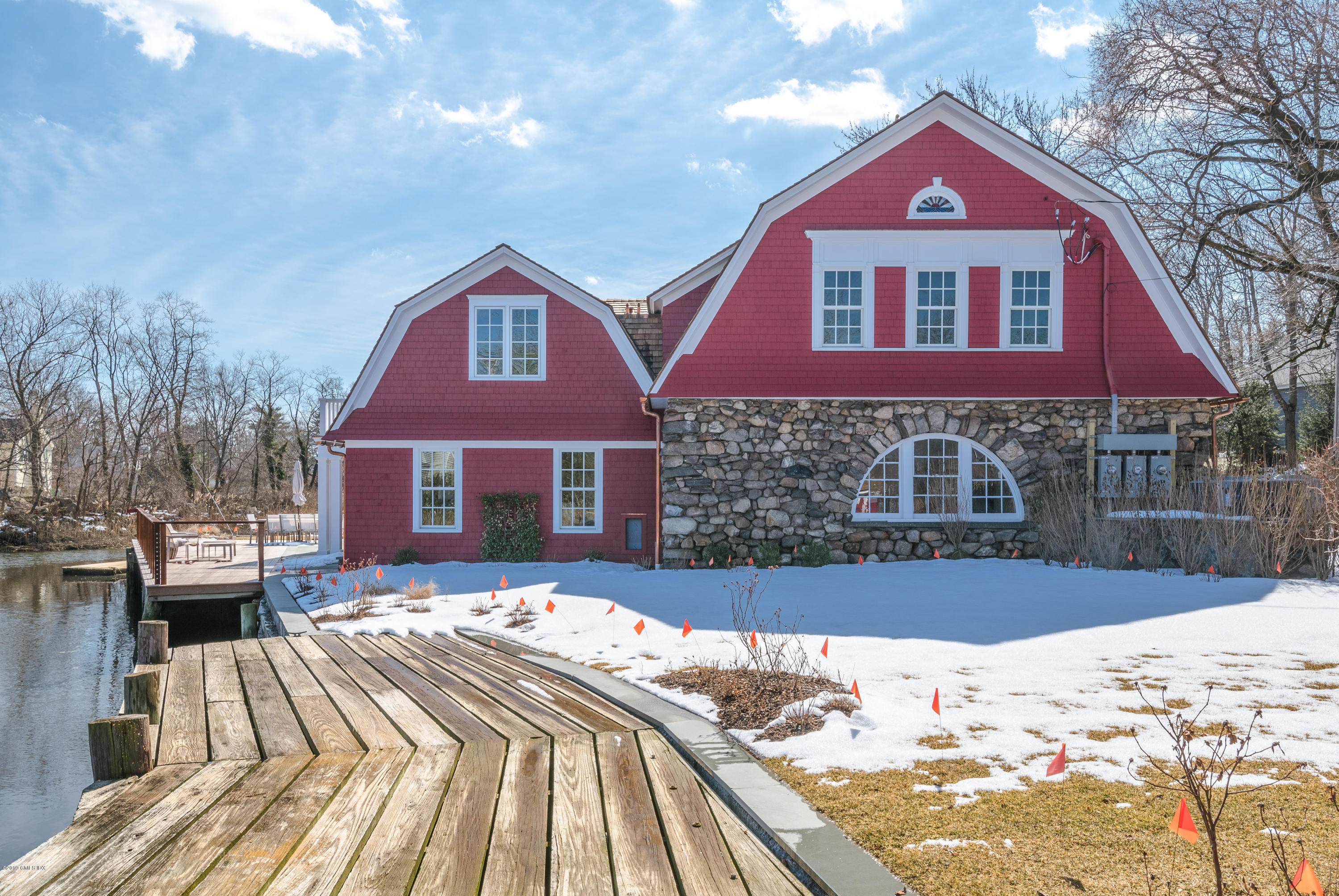 a front view of a house with a yard covered in snow
