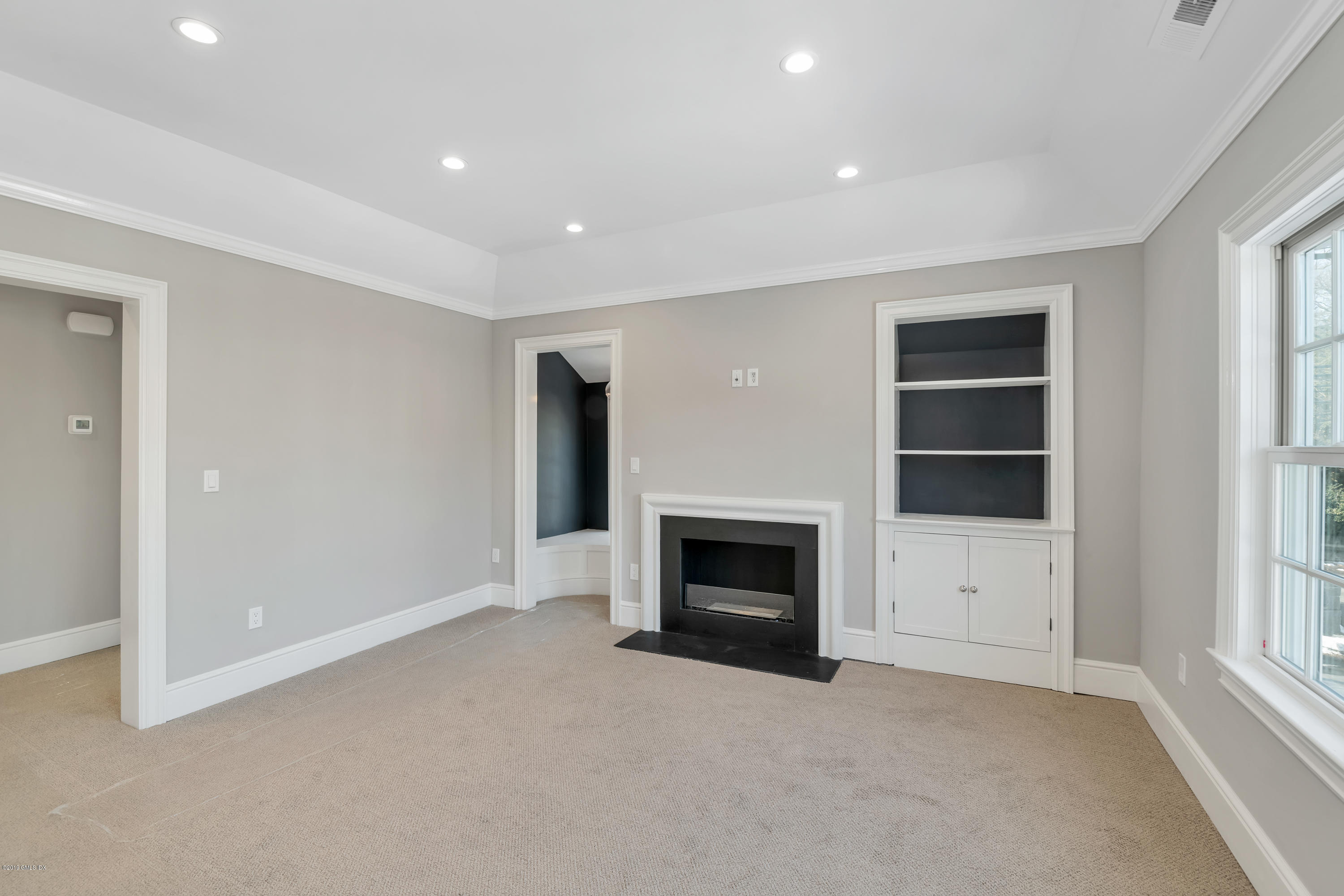 350 Riverside Avenue, Unit B Riverside, CT 06878 - Photo 9 of 15 an empty room with a fireplace and window