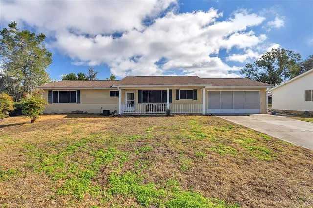 a front view of house with yard and trees around