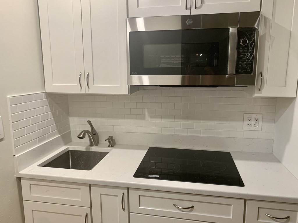 21 Beacon Street, Unit 7L Boston, MA 02108 - Photo 12 of 18 a kitchen with a sink and cabinets