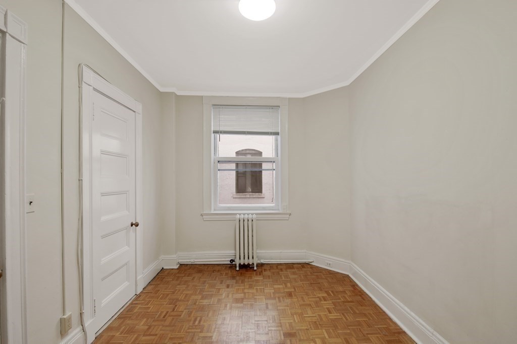 21 Beacon Street, Unit 7L Boston, MA 02108 - Photo 13 of 18 a view of an empty room with a window