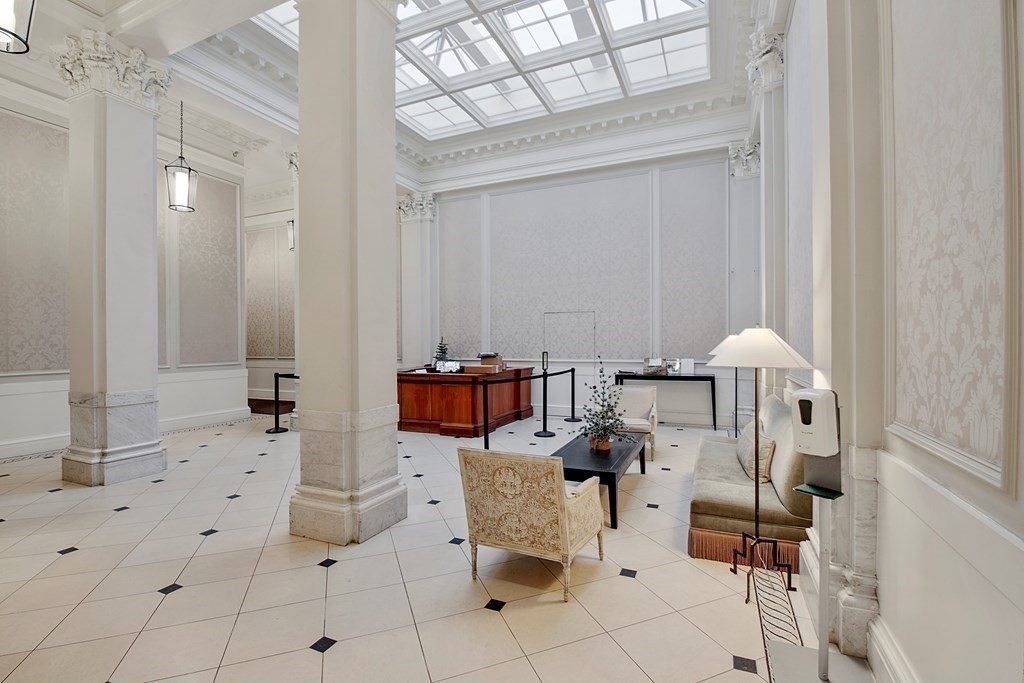 21 Beacon Street, Unit 7L Boston, MA 02108 - Photo 3 of 18 a living room with furniture a table and chairs