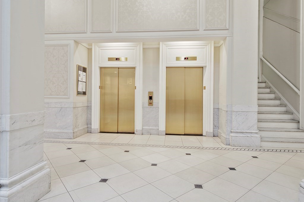 21 Beacon Street, Unit 7L Boston, MA 02108 - Photo 7 of 18 a view of a hallway with wooden floor and cabinet