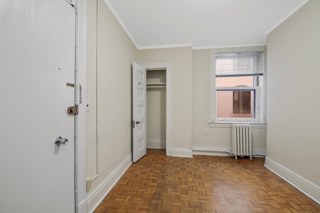 21 Beacon Street, Unit 7L Boston, MA 02108 - Photo 10 of 18 a view of an empty room with window and closet