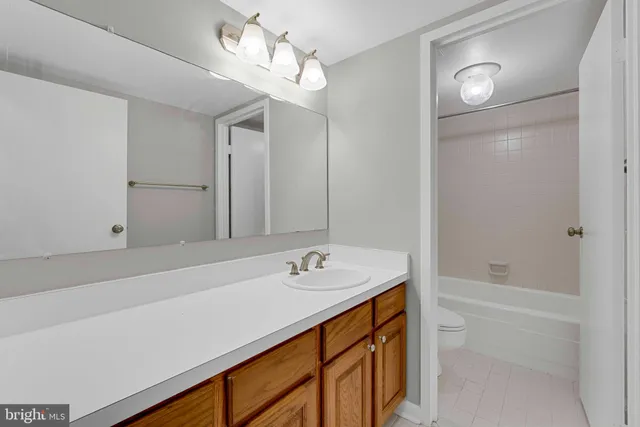 a bathroom with a sink a shower and a mirror