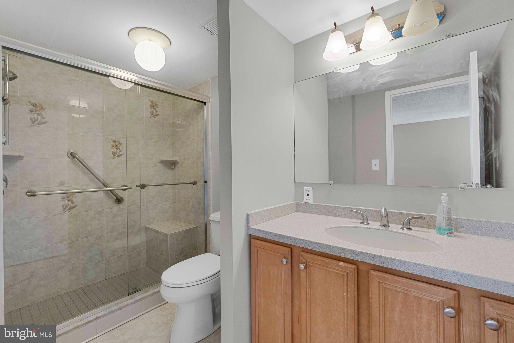 205 East Joppa Road, Unit 1902 Towson, MD 21286 - Photo 23 of 27 a bathroom with a sink a toilet and shower