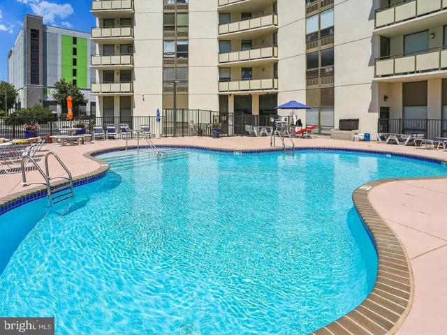 a swimming pool with outdoor seating and yard