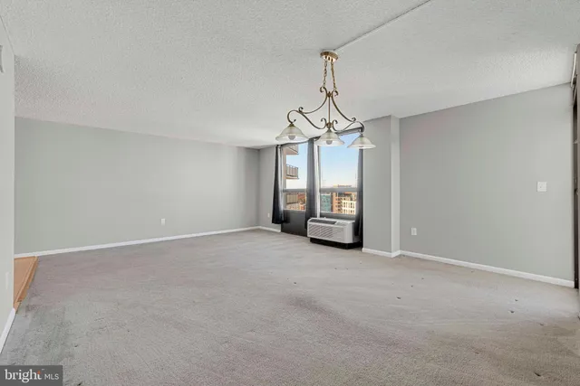 a view of a room with windows and ceiling fan