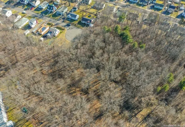 a aerial view of residential houses with yard
