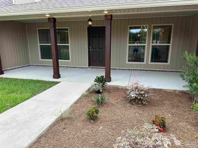 a large kitchen with stainless steel appliances kitchen island granite countertop a stove a sink and a refrigerator