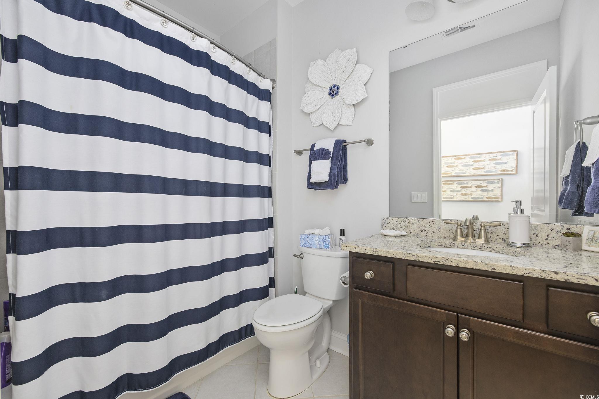 1906 Silver Spring Lane Myrtle Beach, SC 29577 - Photo 20 of 40 Bathroom with vanity, toilet, curtained shower, an