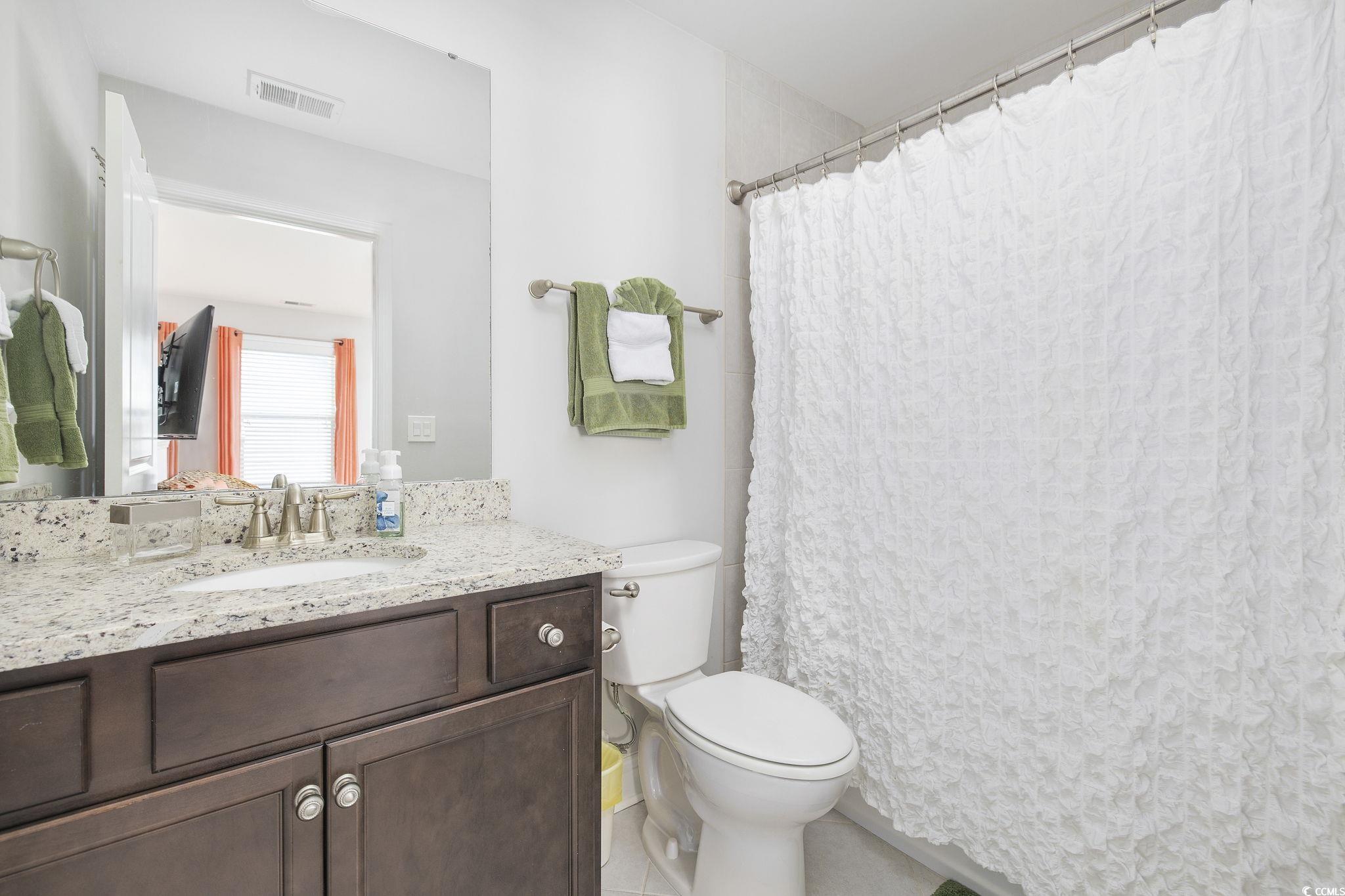 1906 Silver Spring Lane Myrtle Beach, SC 29577 - Photo 24 of 40 Bathroom with tile patterned floors, toilet, curta
