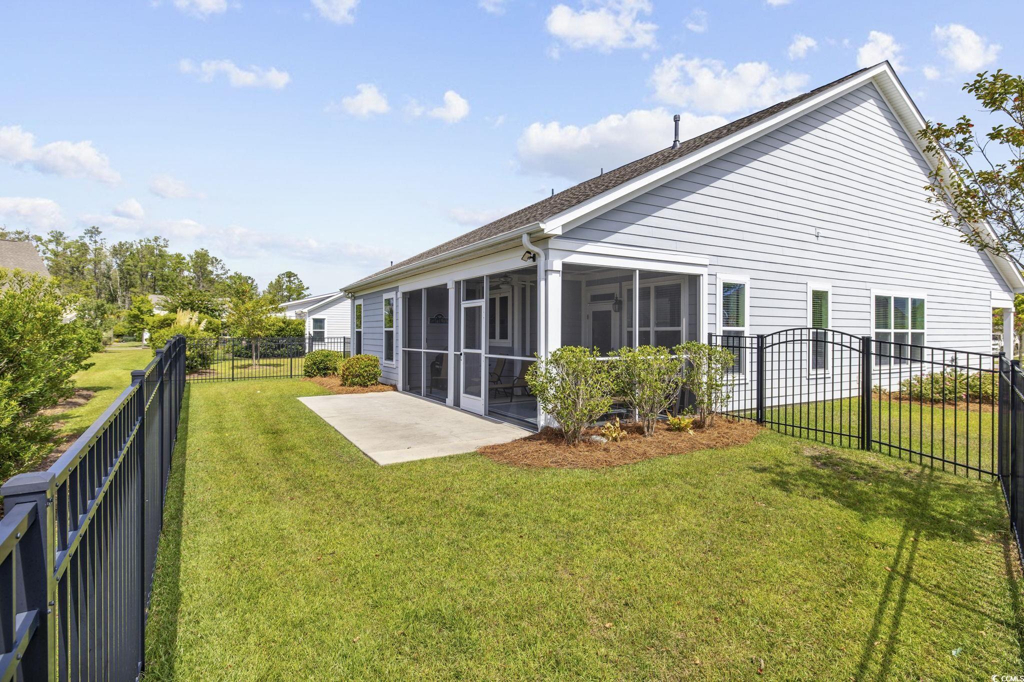1906 Silver Spring Lane Myrtle Beach, SC 29577 - Photo 29 of 40 Rear view of property featuring a sunroom, a patio