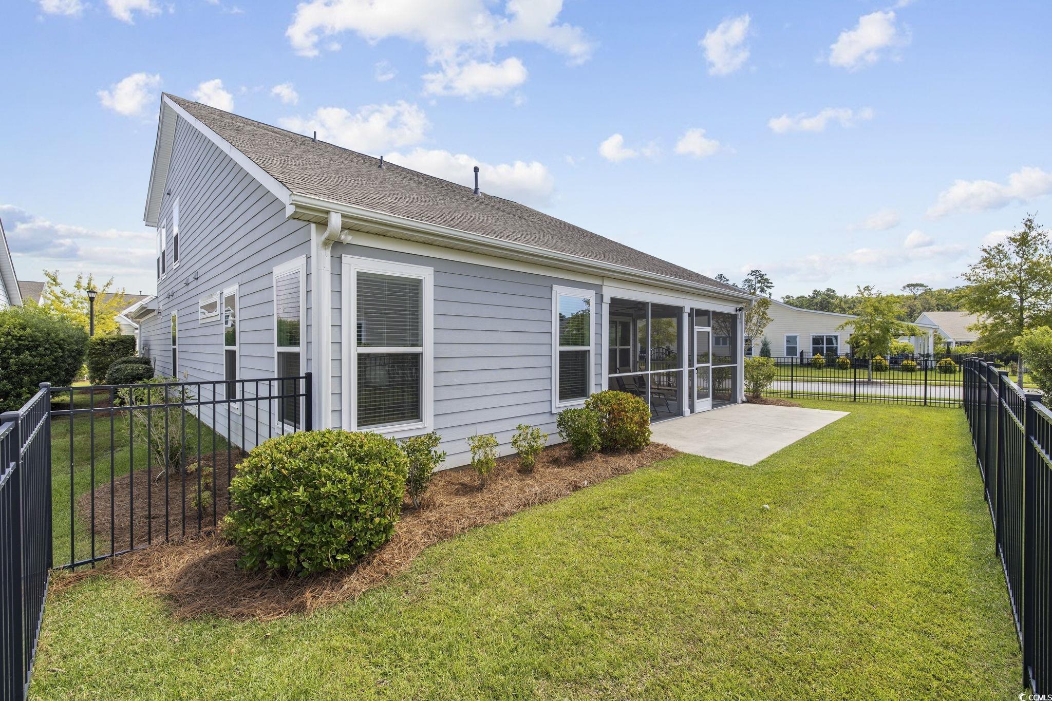 1906 Silver Spring Lane Myrtle Beach, SC 29577 - Photo 30 of 40 Back of property featuring a sunroom and a yard