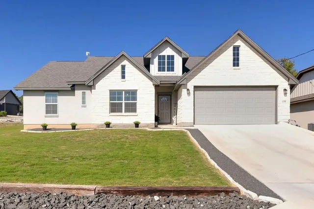 a living room with furniture a flat screen tv and a large window