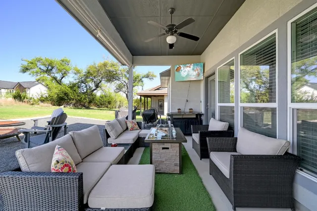 a view of a swimming pool and lounge chairs in back yard