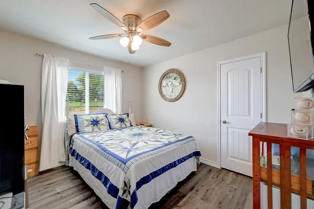 a bathroom with a granite countertop sink toilet and mirror