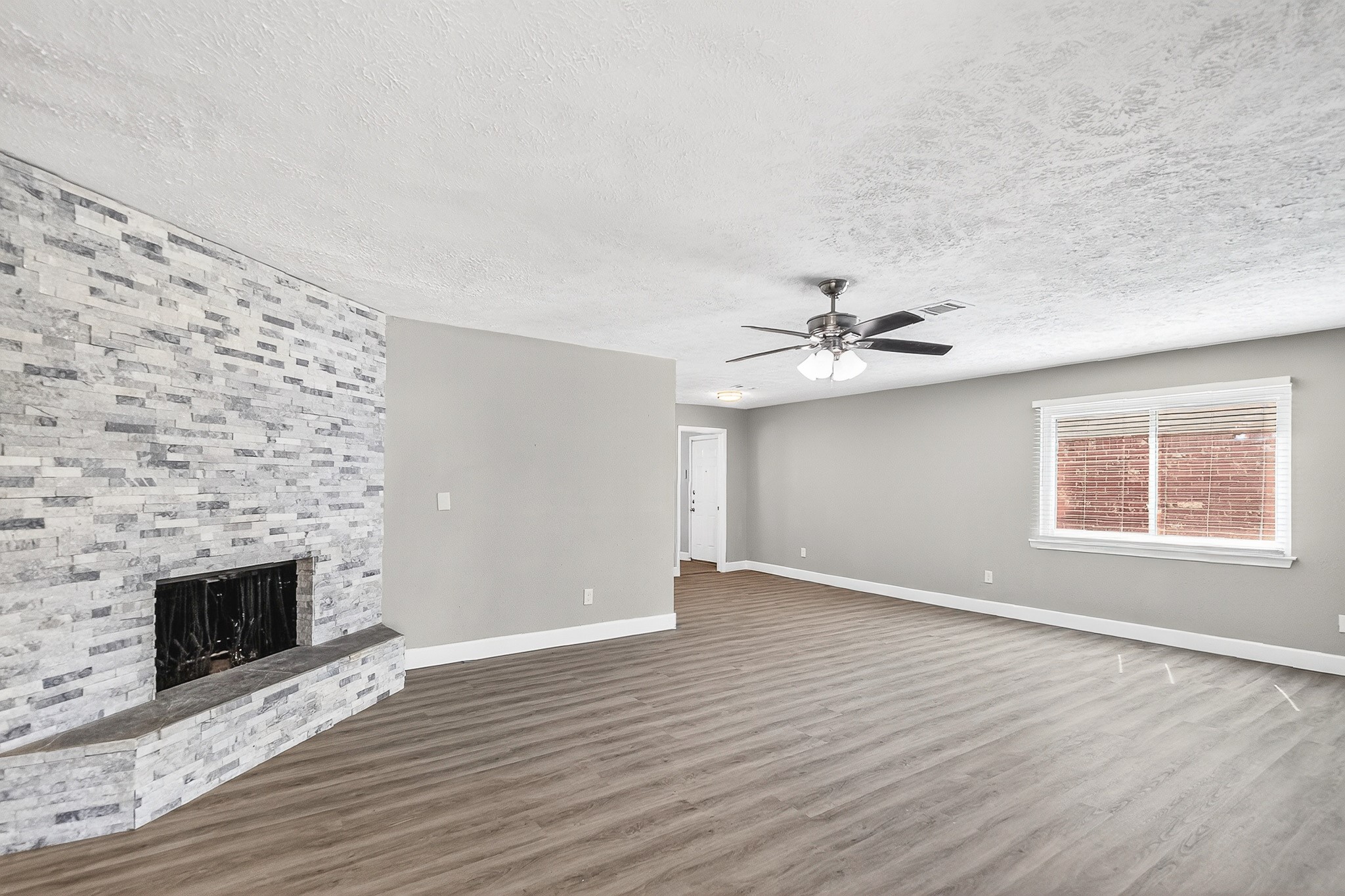2510 Marble Falls Drive Spring, TX 77373 - Photo 5 of 26 an empty room with wooden floor a fireplace and windows