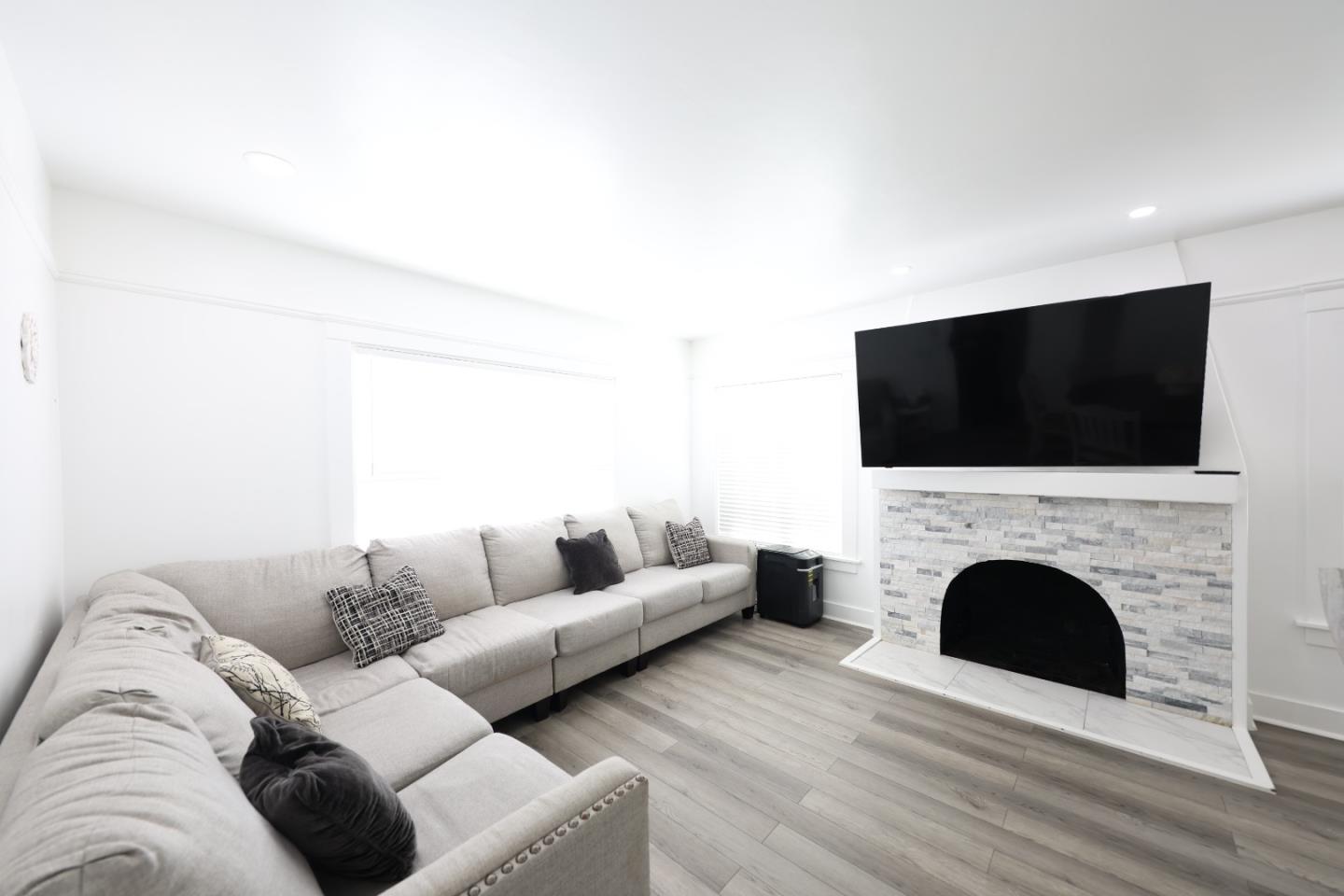 123 Chestnut Street Salinas, CA 93901 - Photo 11 of 25 a living room with a fireplace and a flat screen tv