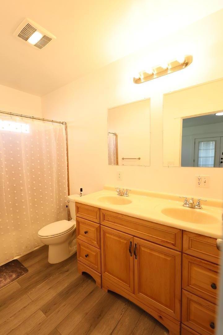 123 Chestnut Street Salinas, CA 93901 - Photo 19 of 25 a bathroom with a granite countertop toilet sink and mirror
