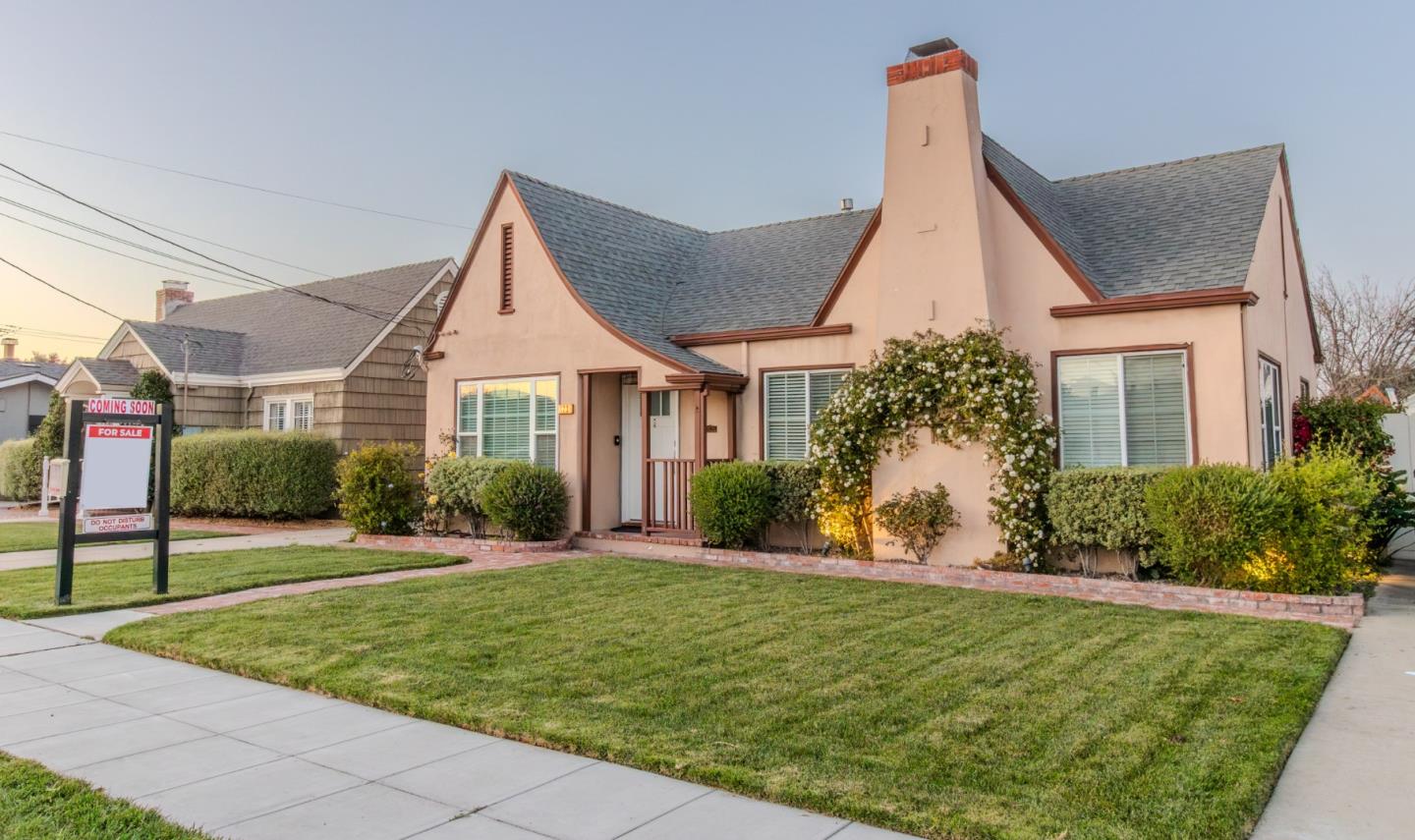 123 Chestnut Street Salinas, CA 93901 - Photo 2 of 25 a front view of a house with a yard and potted plants