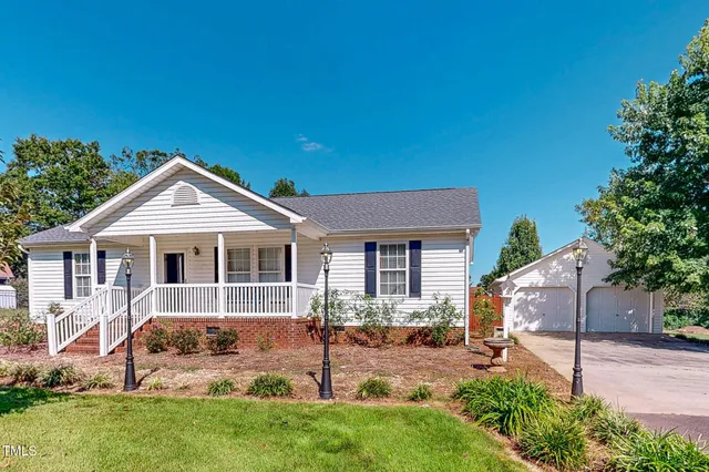 a front view of a house with a yard and porch