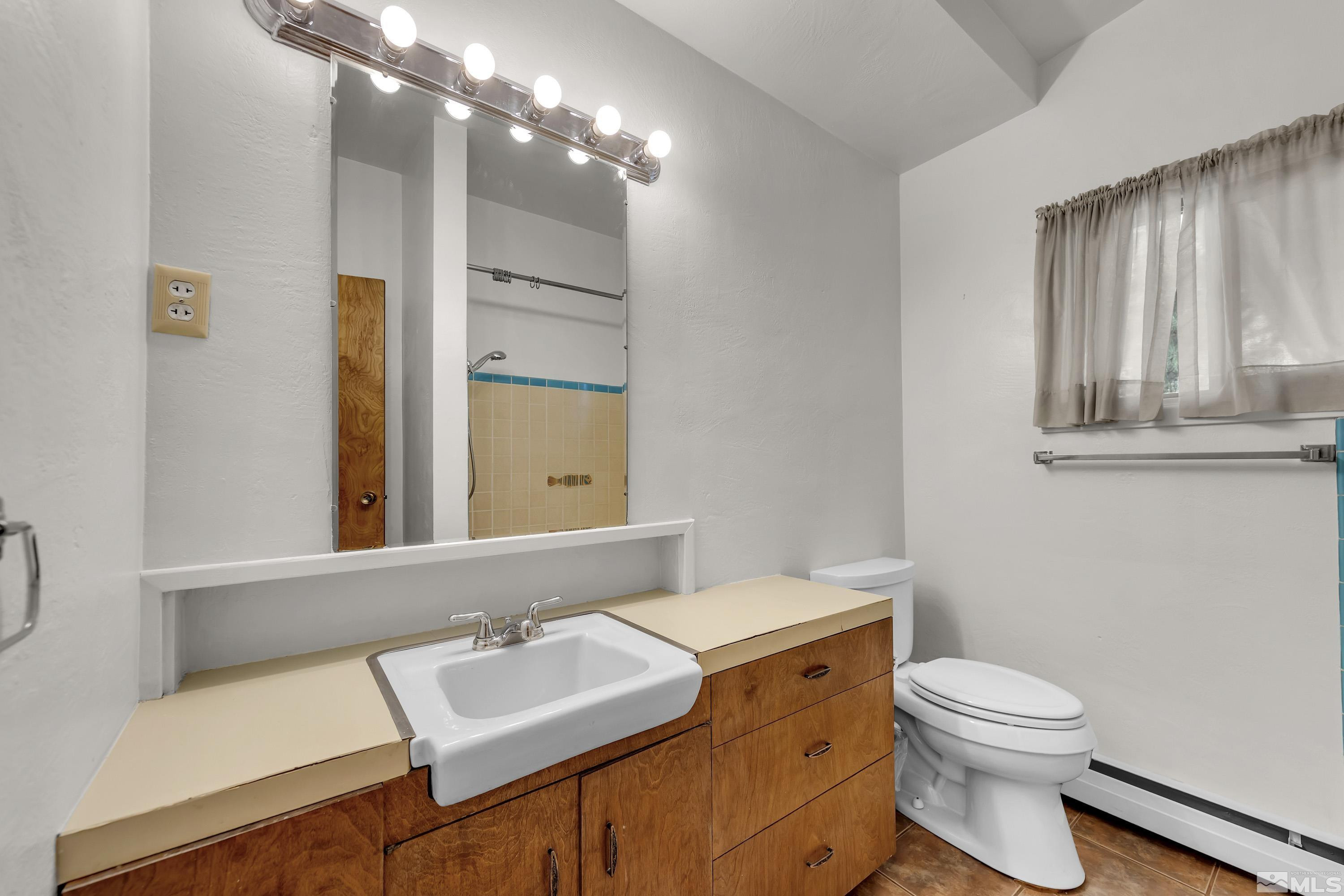 1275 Washington Street Reno, NV 89503 - Photo 20 of 37 a bathroom with a sink a toilet and mirror