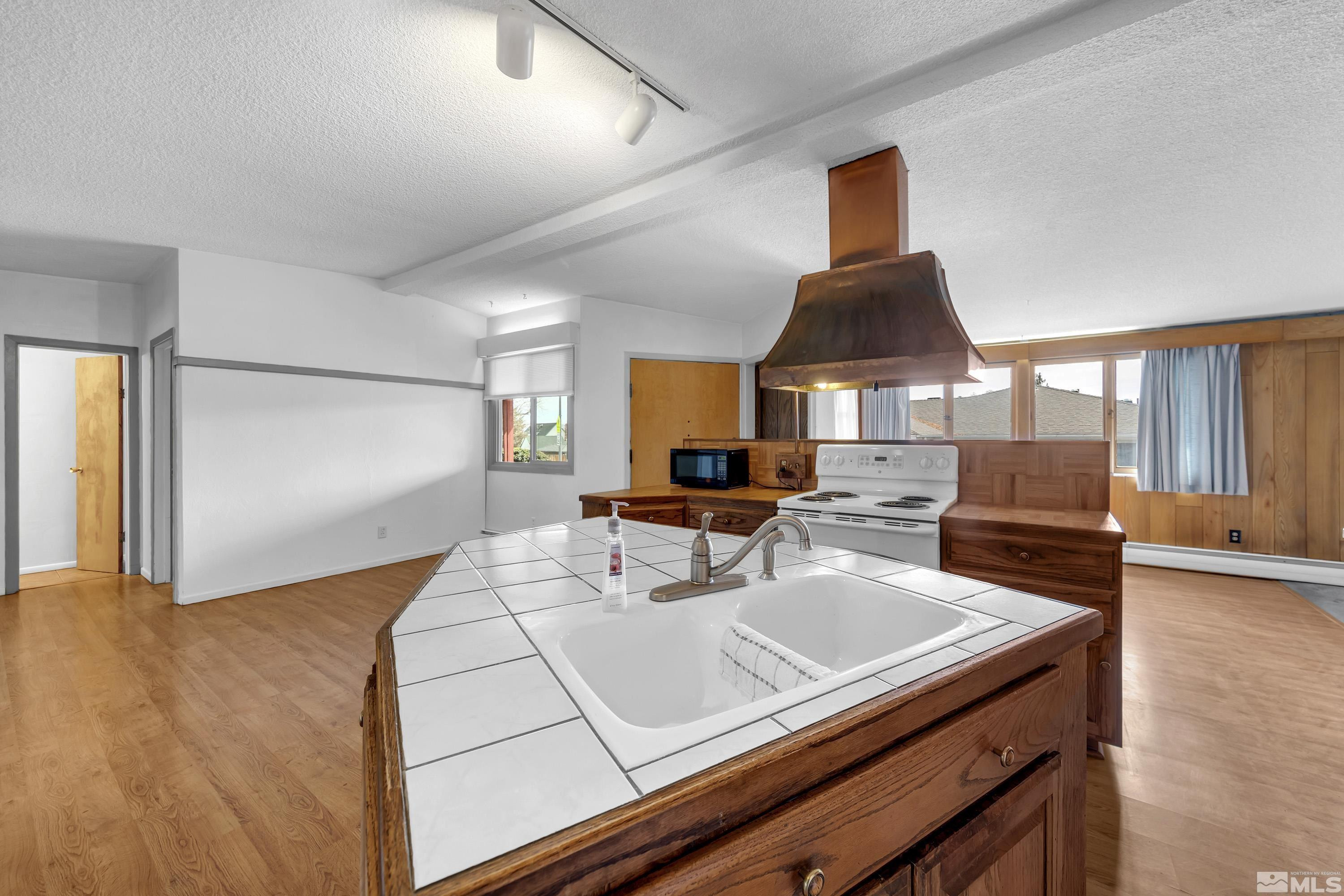 1275 Washington Street Reno, NV 89503 - Photo 8 of 37 a kitchen with a sink a stove and chairs