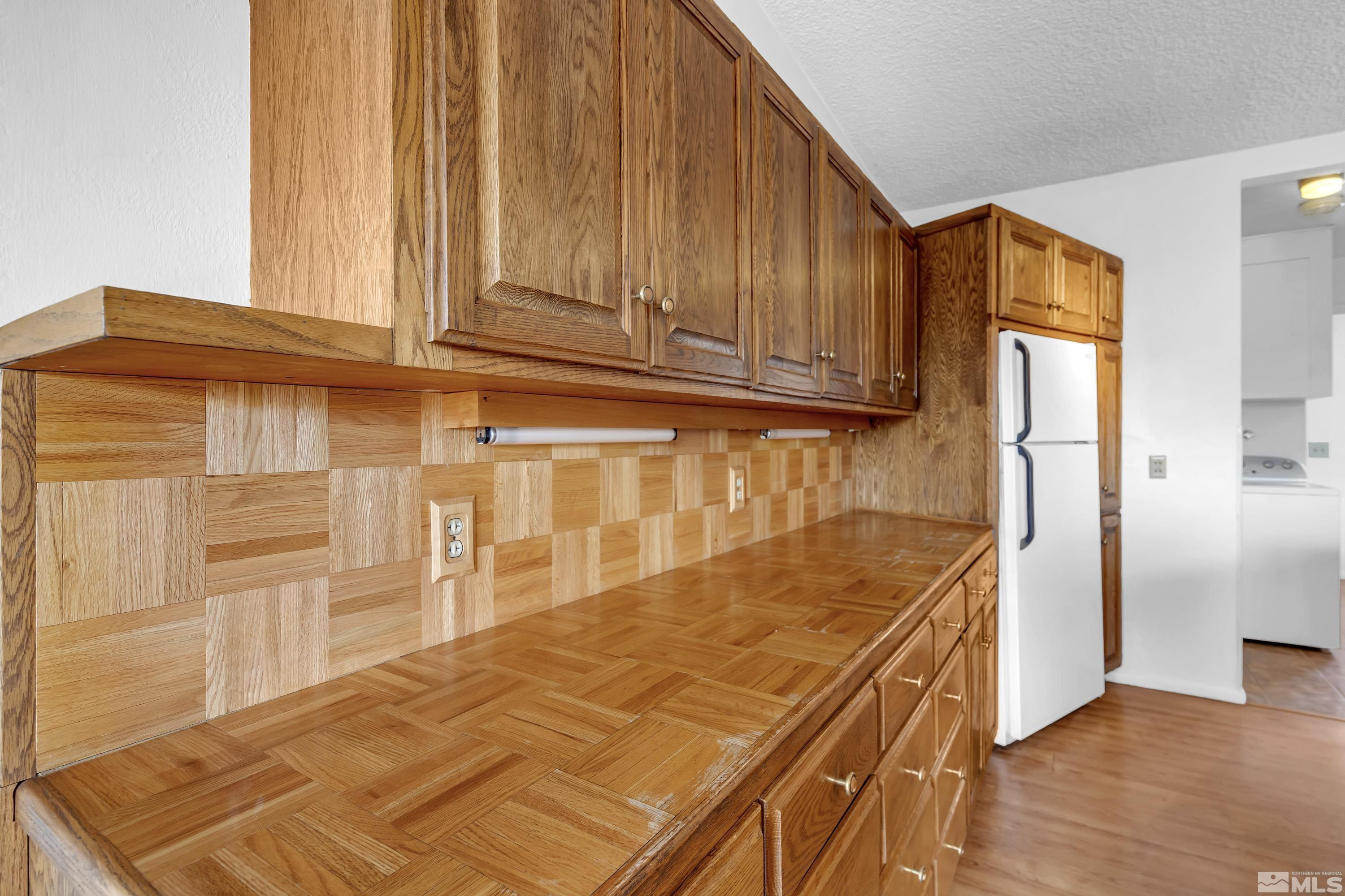 1275 Washington Street Reno, NV 89503 - Photo 9 of 37 a kitchen with granite countertop cabinets and refrigerator