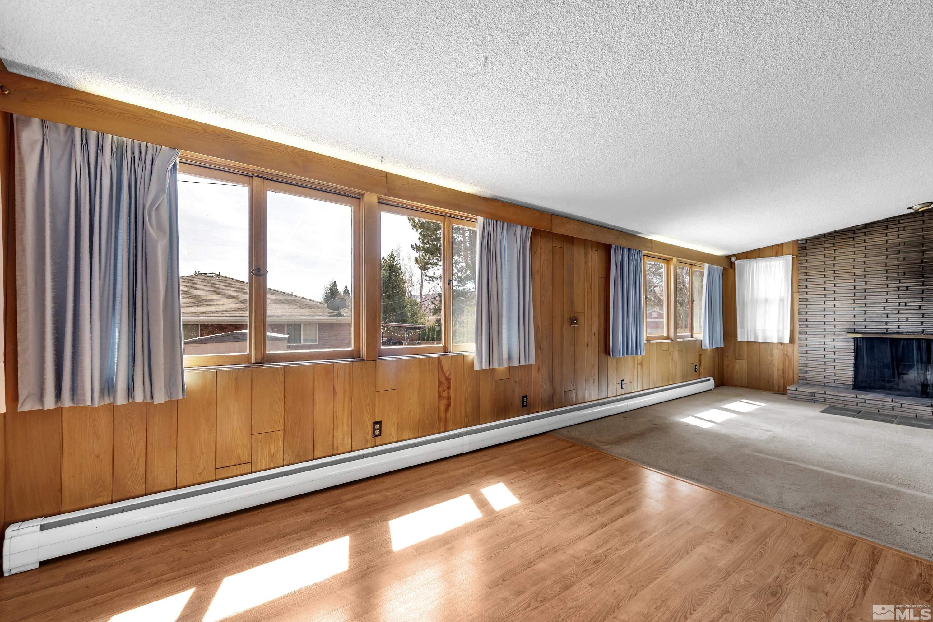 1275 Washington Street Reno, NV 89503 - Photo 10 of 37 a view of an empty room with a window and wooden floor