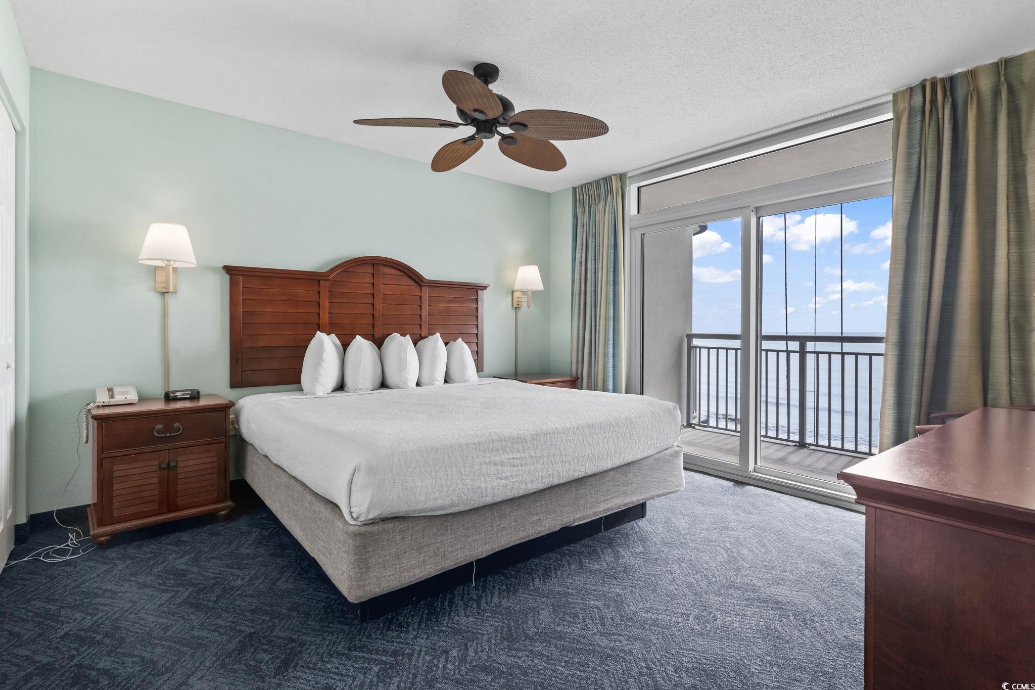2007 South Ocean Boulevard, Unit 607 Myrtle Beach, SC 29577 - Photo 21 of 40 Bedroom with a textured ceiling, access to exterio